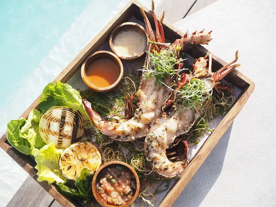 Grilled lobster platter served beside the pool at Azure Beach Club