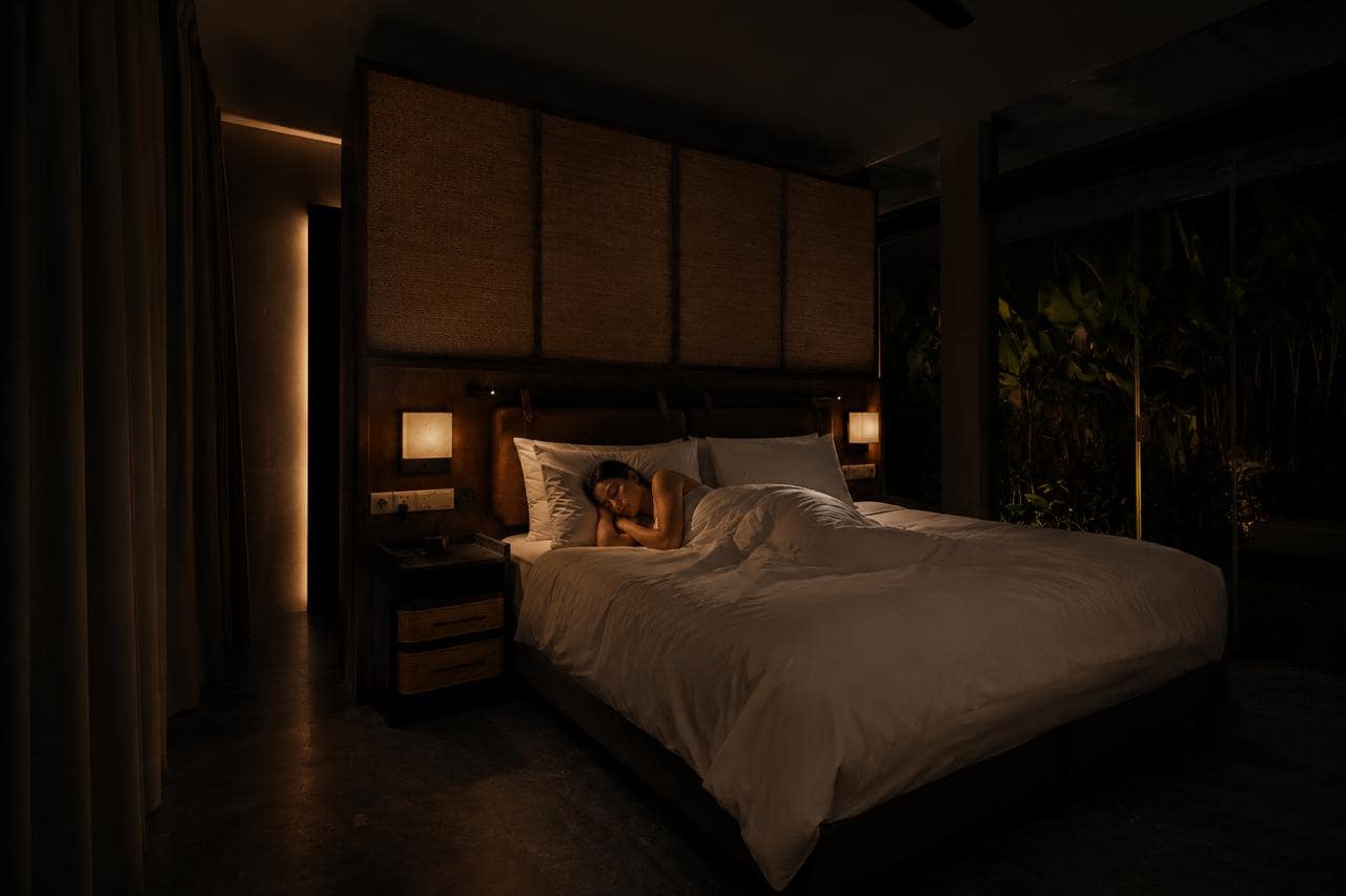 Guest resting in a darkened bedroom at Pronoia