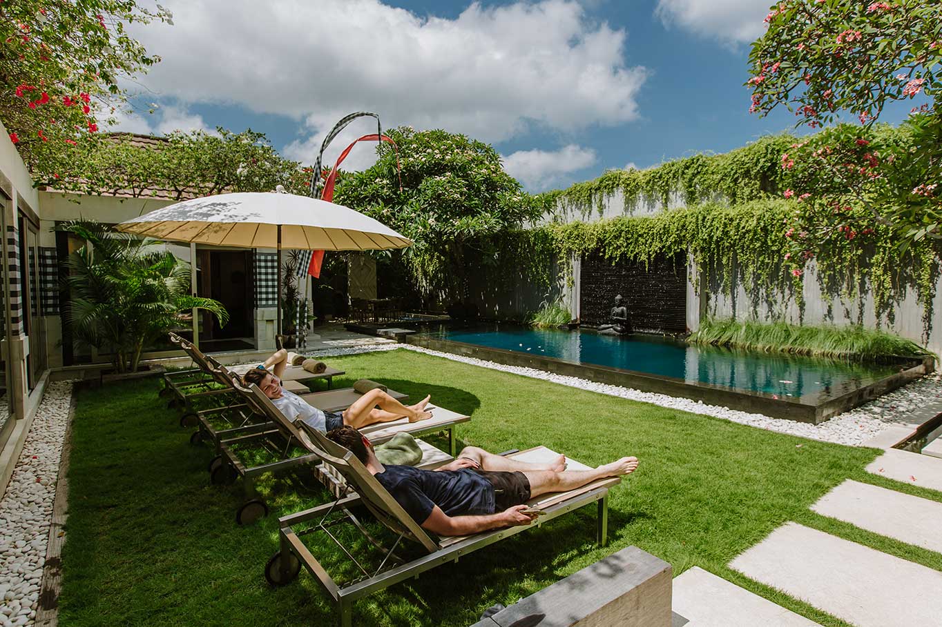 Villa garden with sun loungers beside the private pool