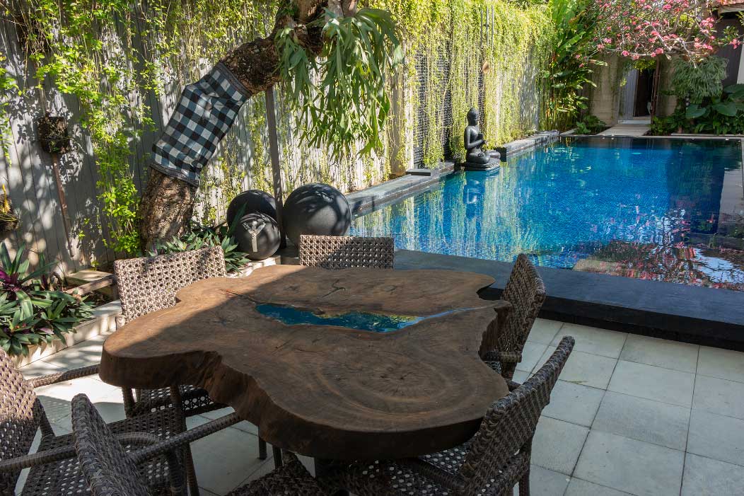 Outdoor dining table beside the private pool