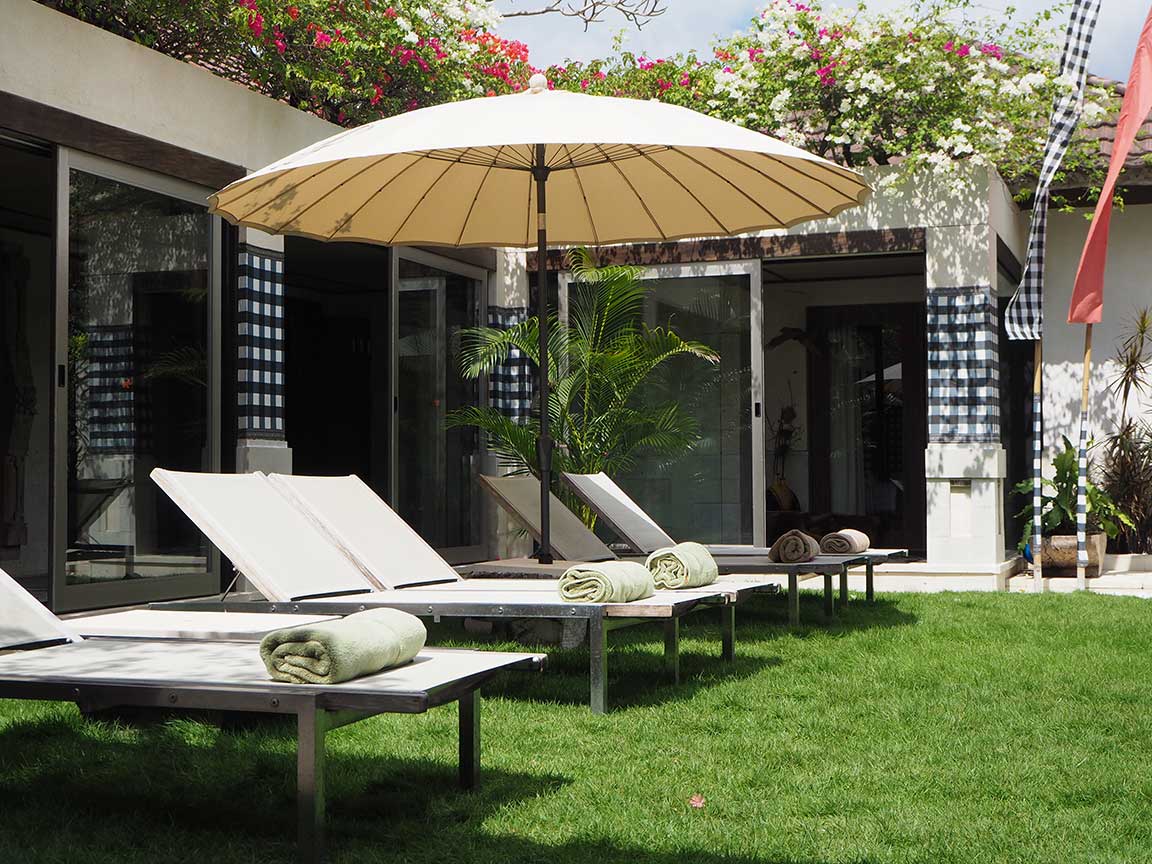 Sun loungers on the villa lawn