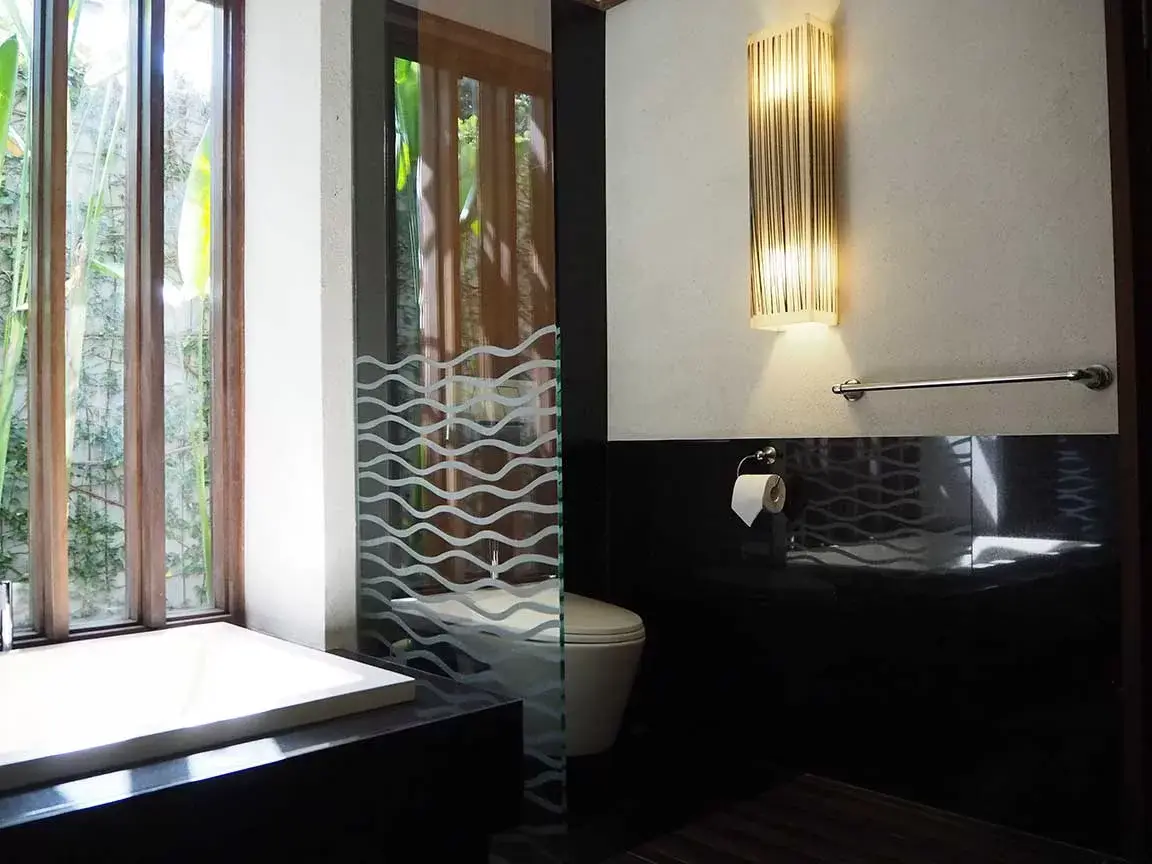 Bathtub beside full-height windows