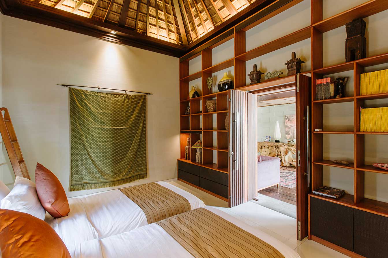 Twin bedroom with timber shelving and a vaulted ceiling