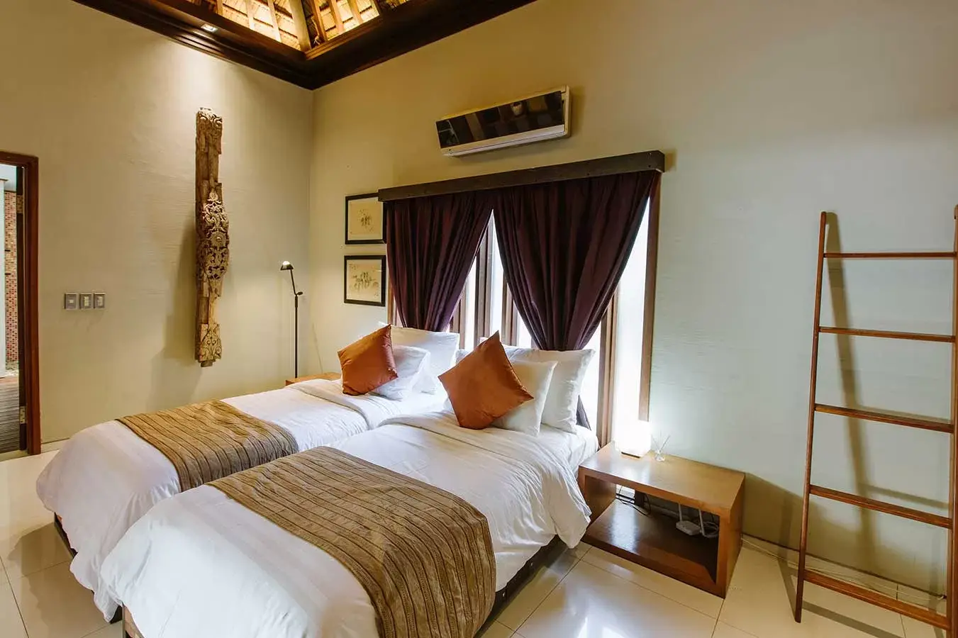 Villa bedroom with a vaulted timber ceiling
