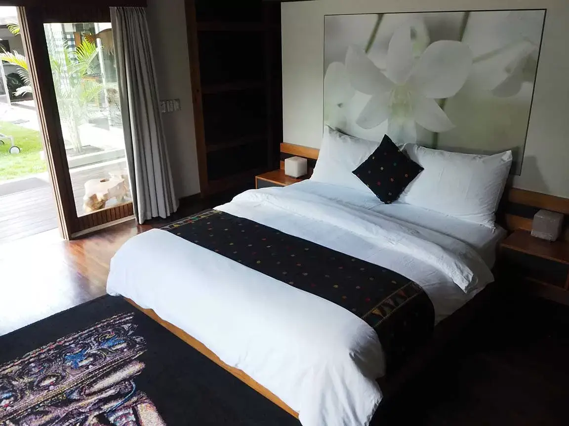 Bedroom with upholstered bed and garden access