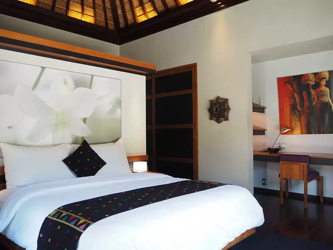 Bedroom with upholstered bed and contemporary artwork