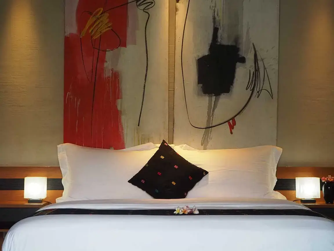 Bedroom with red artwork above the bed