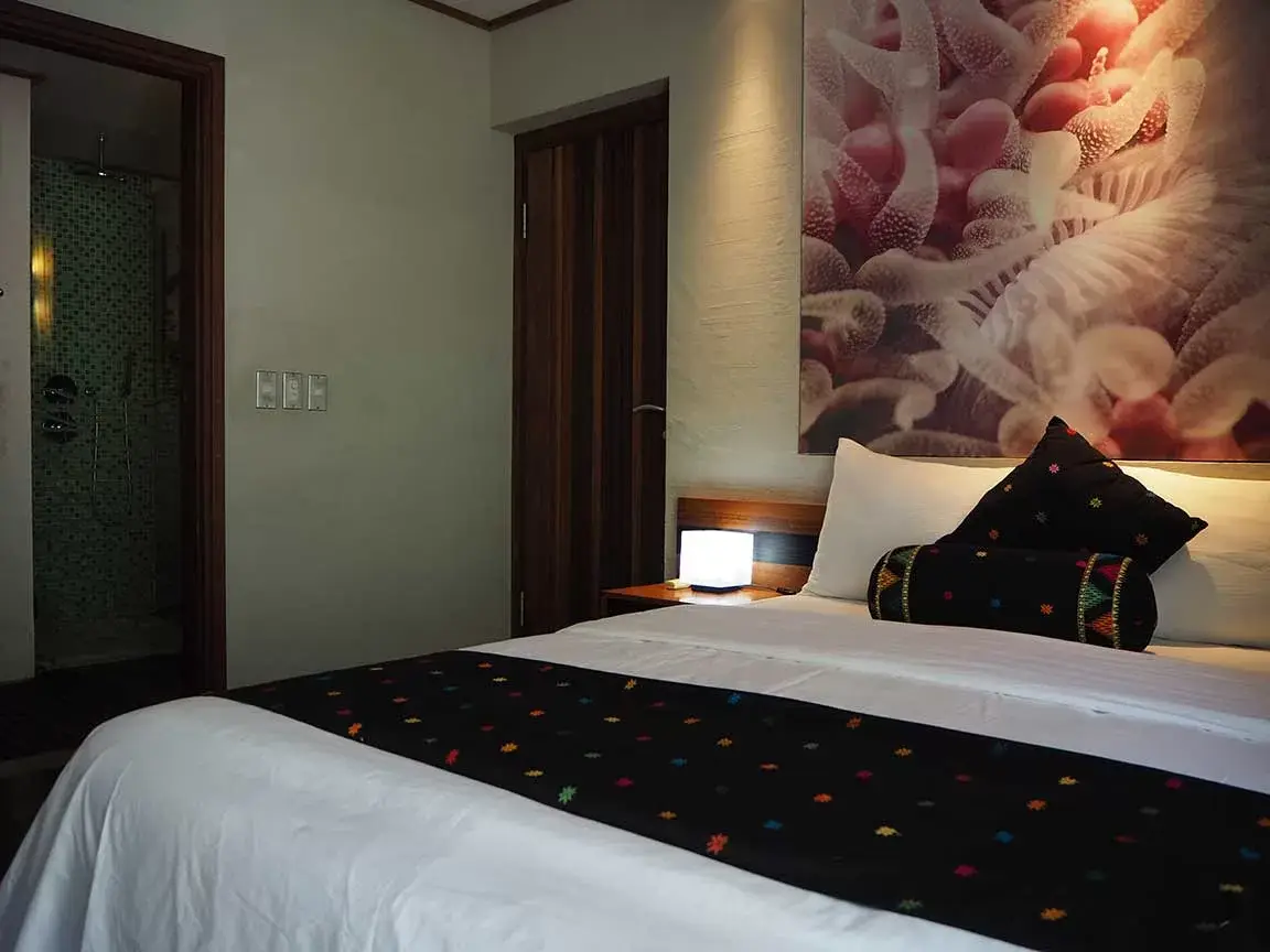 Bedroom with floral artwork and timber wardrobe