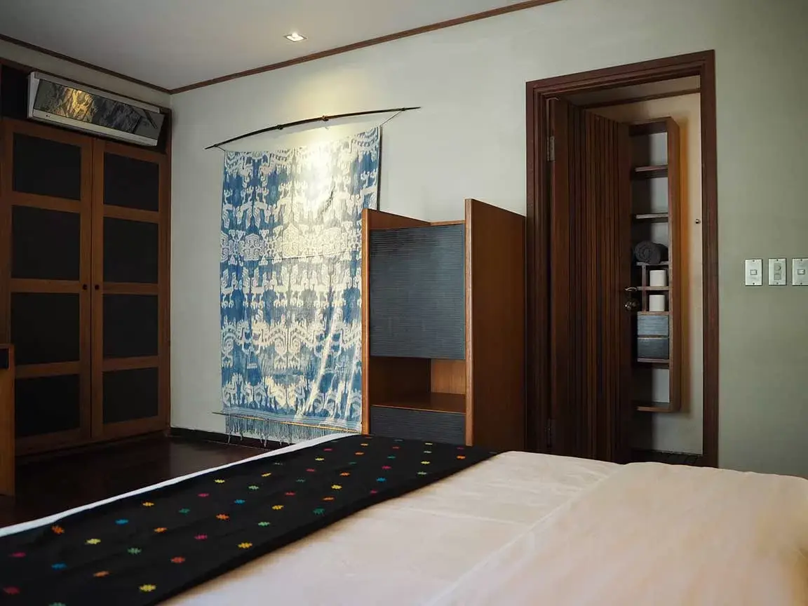 Bedroom with blue artwork and writing desk