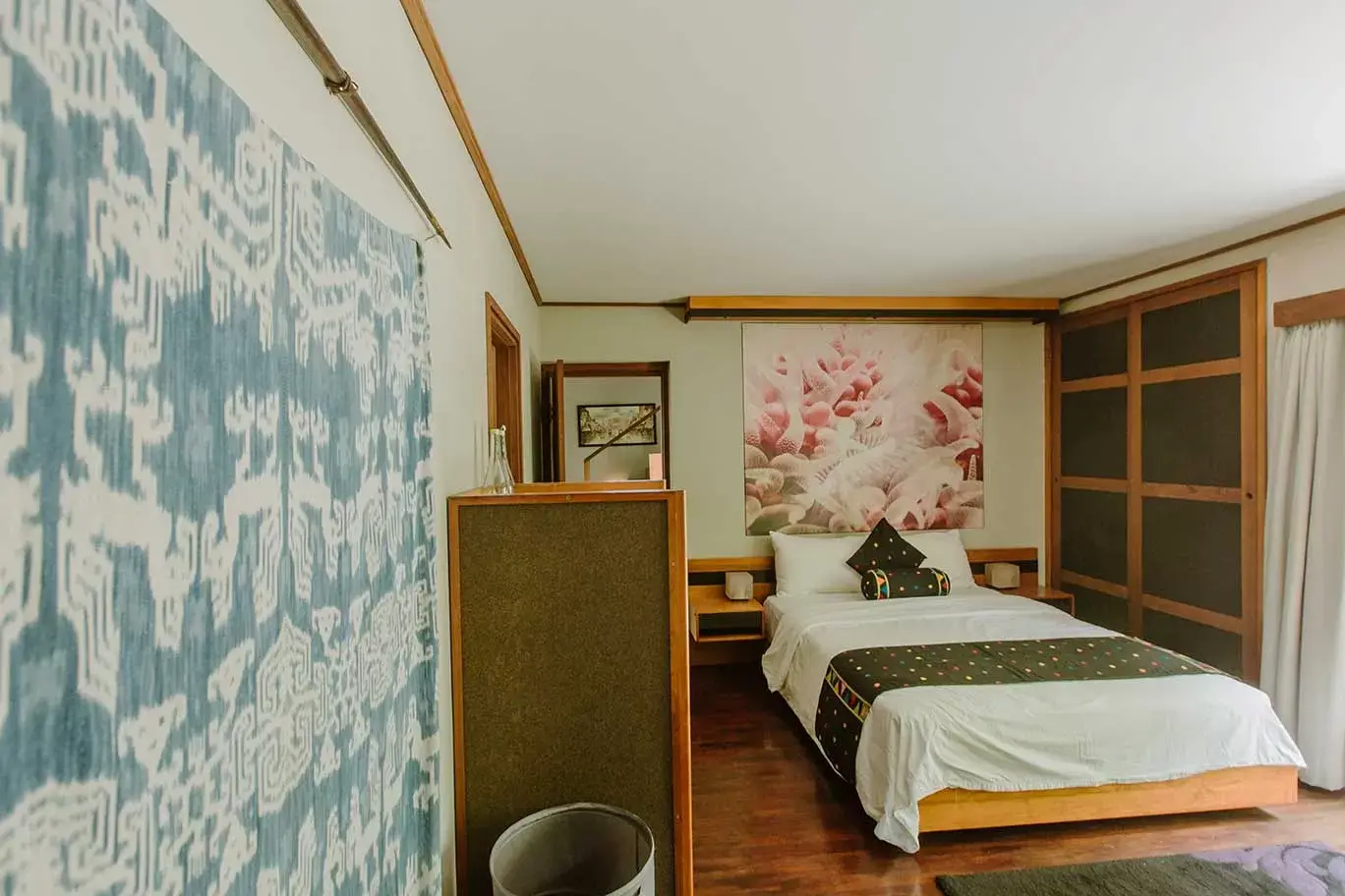 Bedroom with patterned feature wall and timber furniture