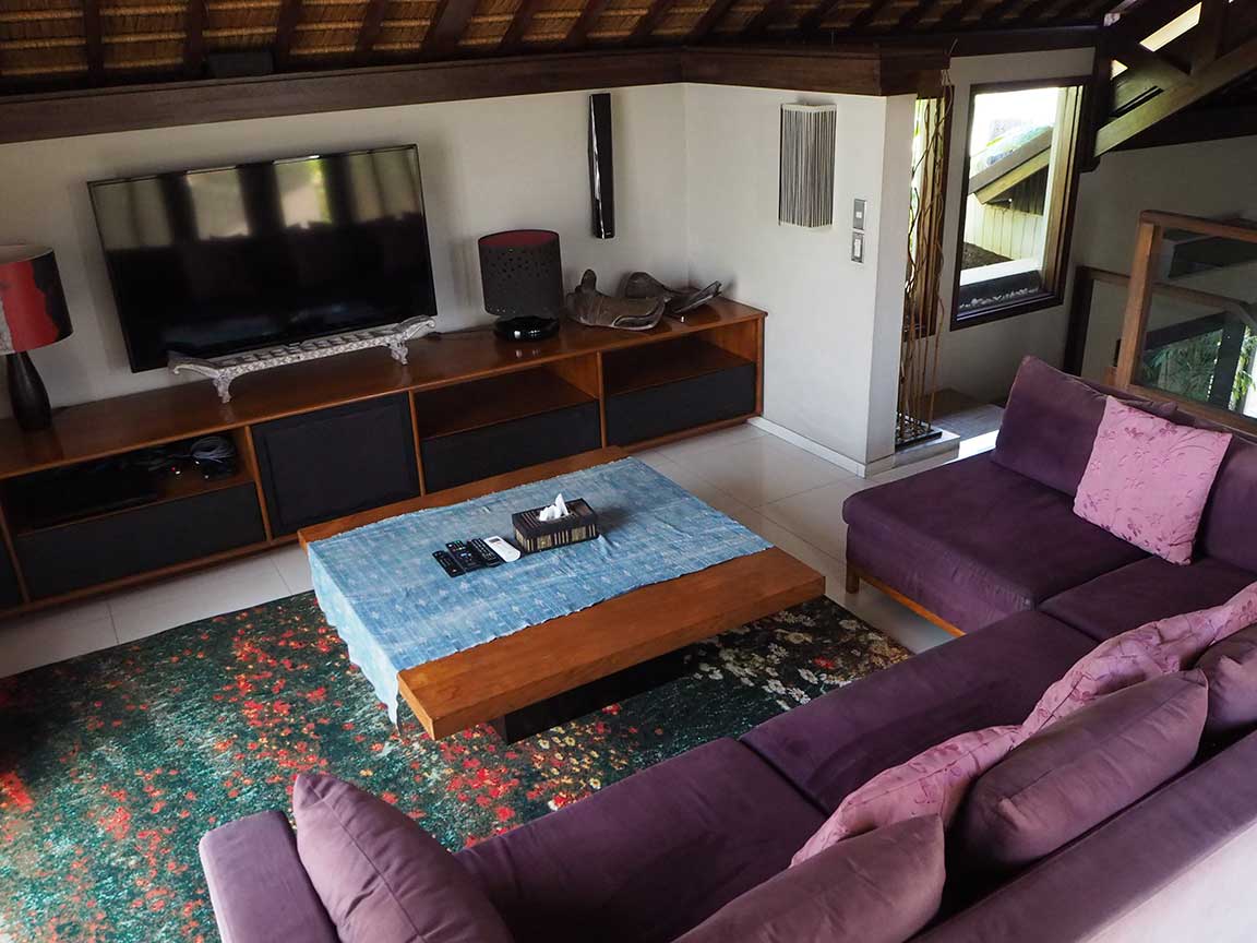Sunken lounge with television and timber furniture