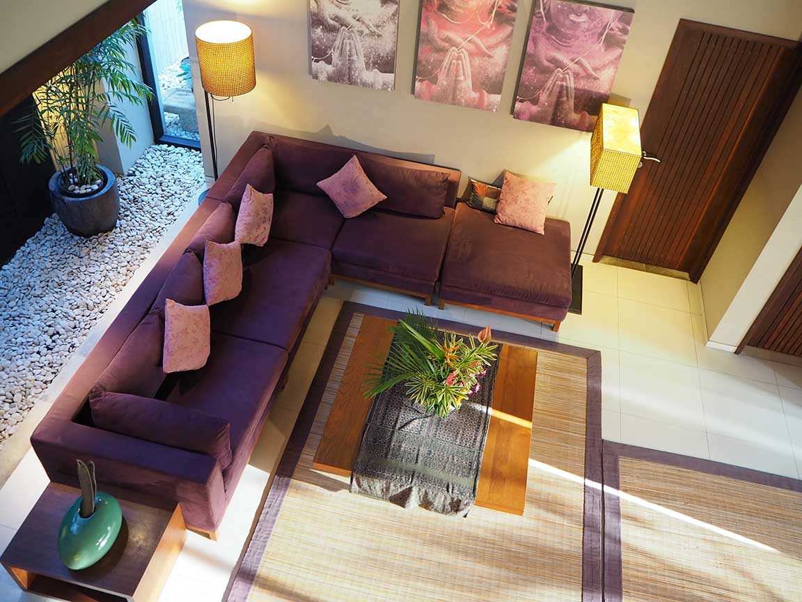 Living room with purple sofas and a coffee table